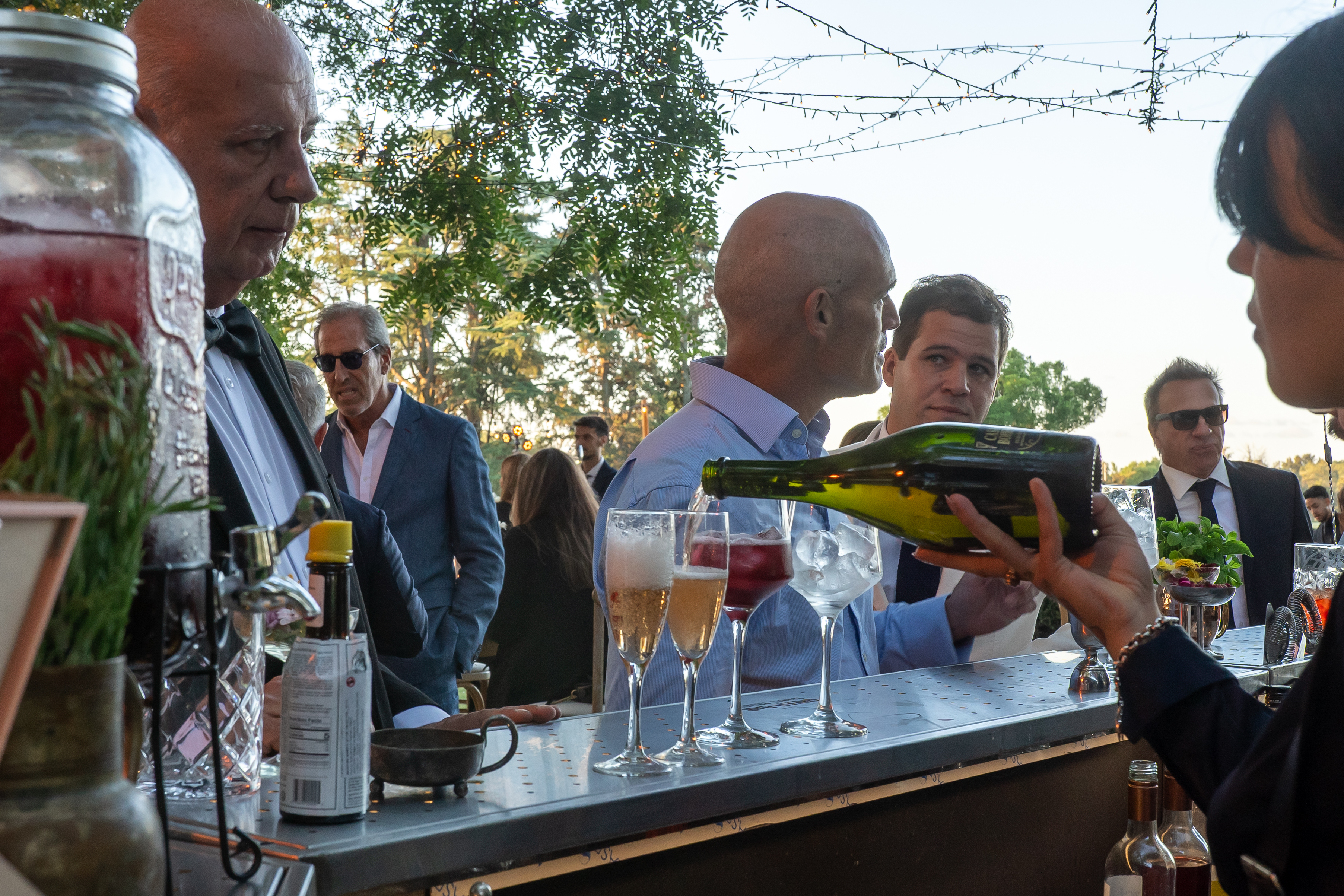 Bartender sirviendo champagne en barra de vinos